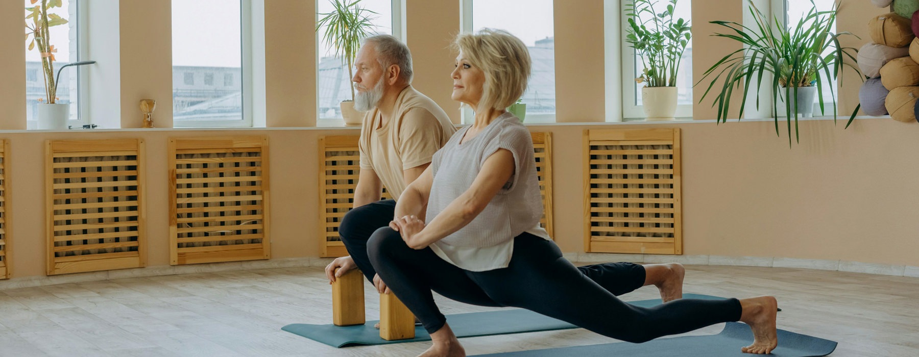 Lifestyle photo of a man and woman doing yoga